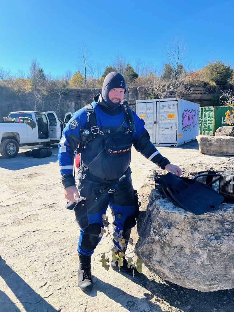 Forrest Drake in a drysuit preparing to dive at the quarry