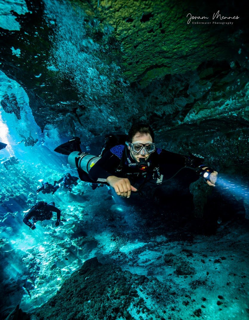 Josh Lefler diving through an underwater cavern